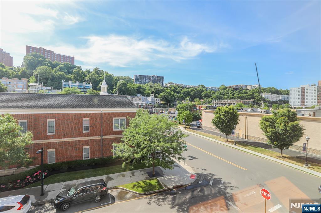 4 Main Street, Unit F Edgewater, NJ 07020 - Photo 8 of 20 a view of a street with a cars parked on the road