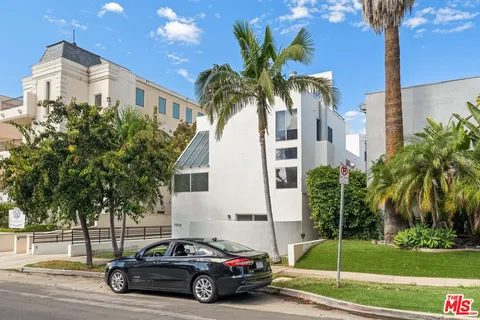 a view of a car parked in front of a house