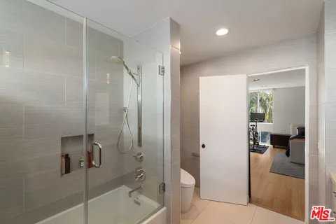 a bathroom with a shower and toilet