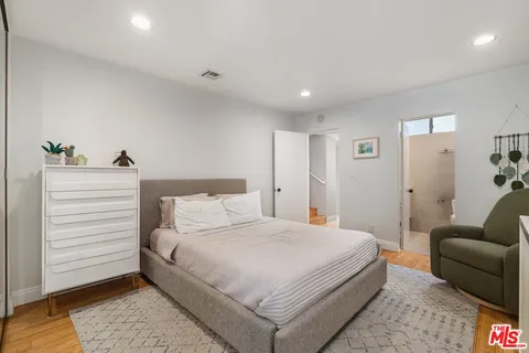 a bedroom with a bed and a couch