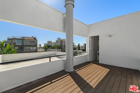 a view of a balcony with wooden floor