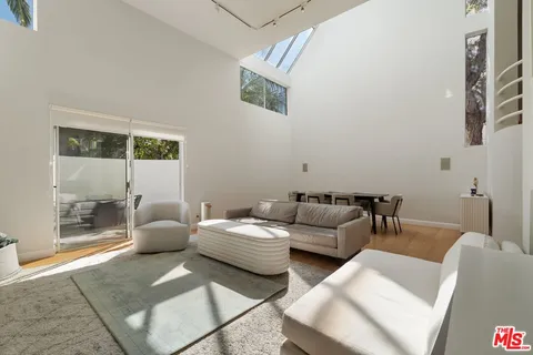 a living room with furniture and a floor to ceiling window