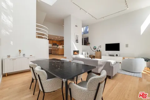 a dining room with furniture and wooden floor