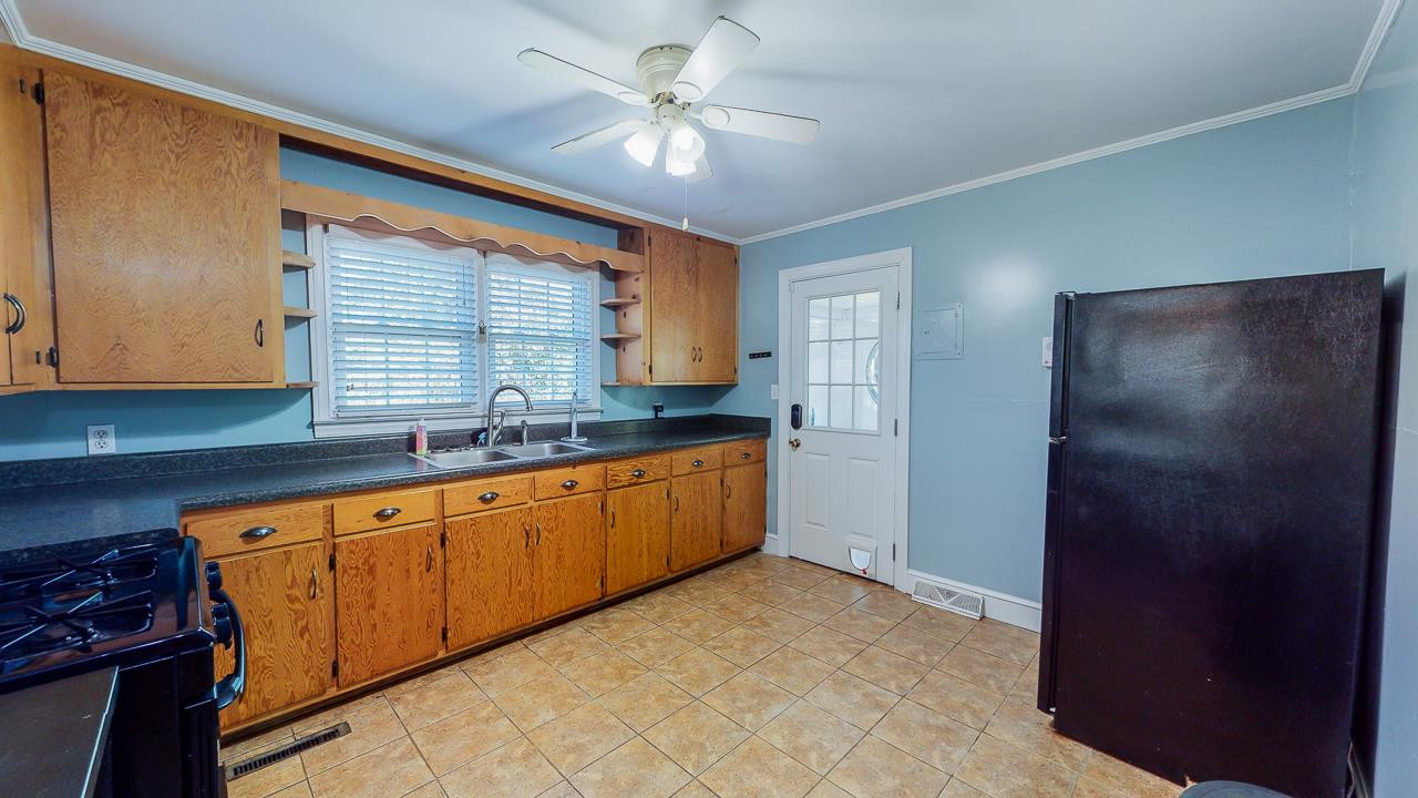 245 Howard Clayton Road Timberlake, NC 27583 - Photo 13 of 30 a kitchen with granite countertop a sink cabinets stainless steel appliances and a counter top space