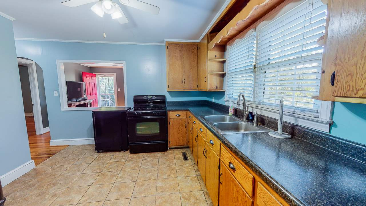 245 Howard Clayton Road Timberlake, NC 27583 - Photo 3 of 30 a kitchen with stainless steel appliances granite countertop a sink a stove and a refrigerator