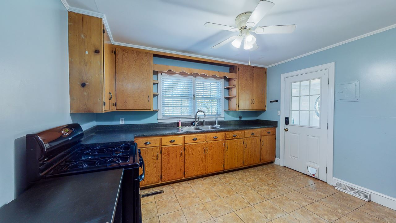 245 Howard Clayton Road Timberlake, NC 27583 - Photo 4 of 30 a kitchen with granite countertop a sink cabinets and window