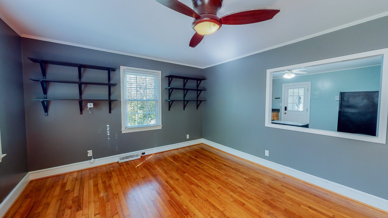 245 Howard Clayton Road Timberlake, NC 27583 - Photo 6 of 30 a view of empty room with window and ceiling fan