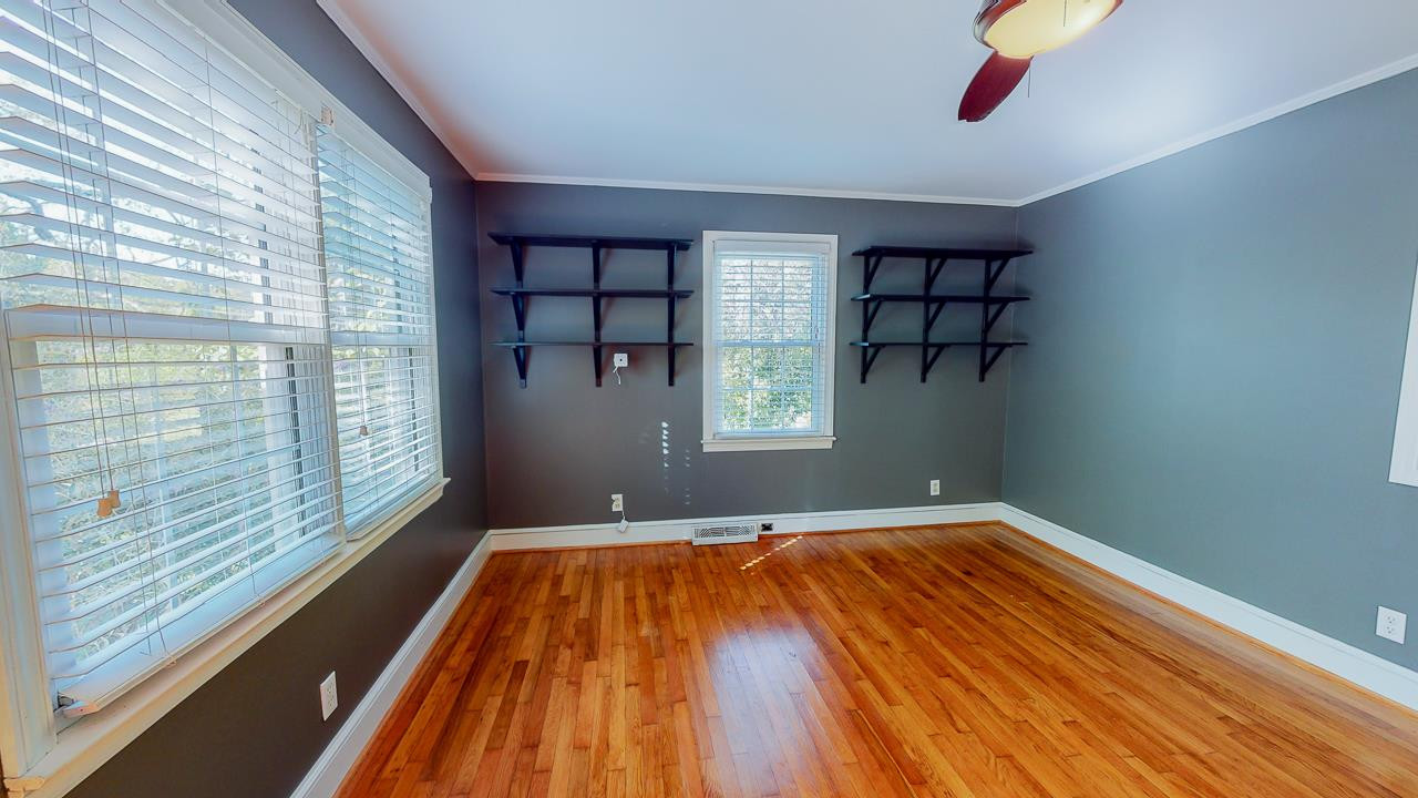 245 Howard Clayton Road Timberlake, NC 27583 - Photo 10 of 30 a view of empty room with wooden floor and fan
