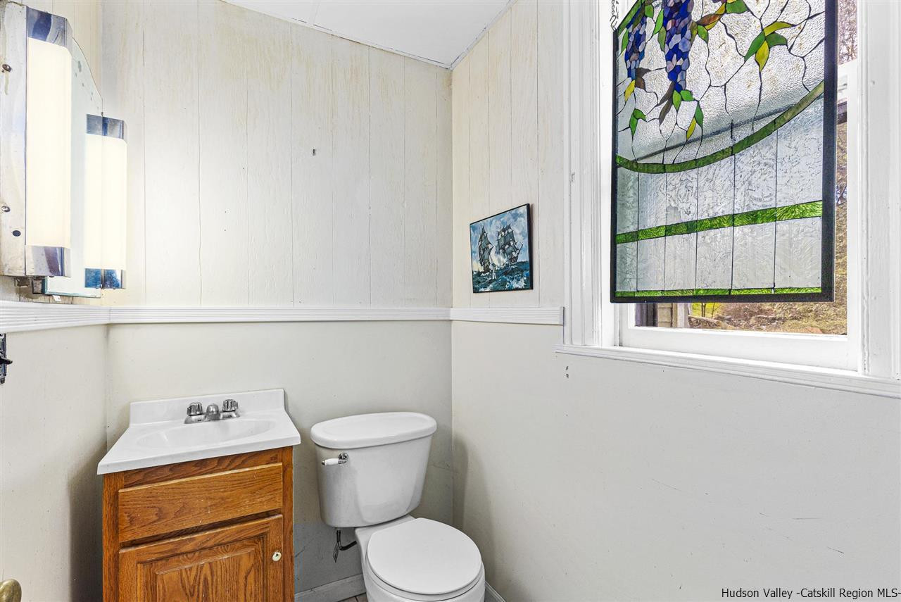Undisclosed Address Kingston, NY 12401 - Photo 21 of 34 a white toilet sitting next to a bathroom sink