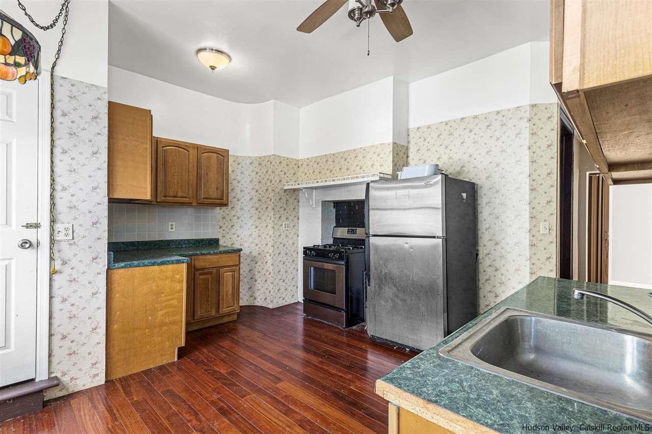 Undisclosed Address Kingston, NY 12401 - Photo 22 of 34 a kitchen with stainless steel appliances granite countertop a refrigerator a stove and a wooden floors