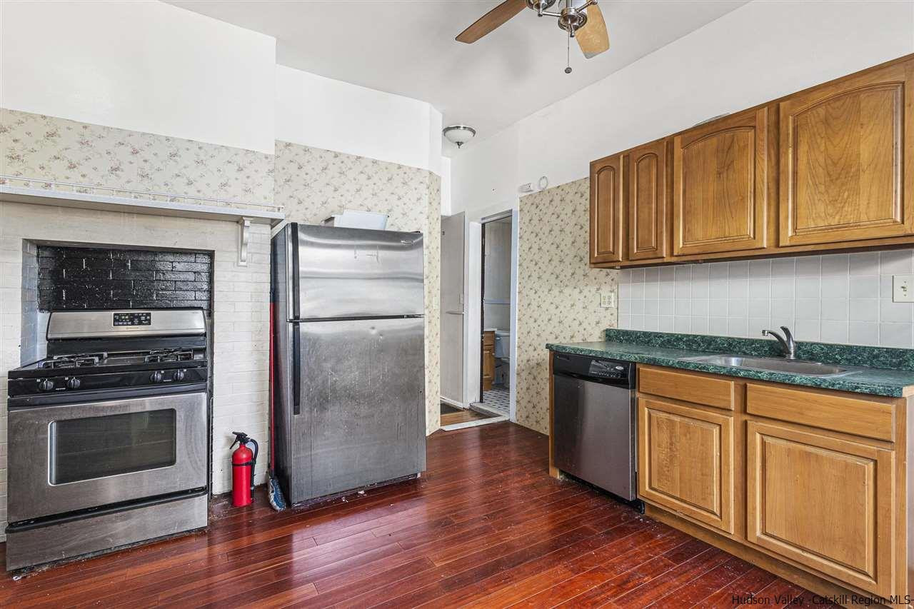 Undisclosed Address Kingston, NY 12401 - Photo 23 of 34 a kitchen with granite countertop wooden floors stainless steel appliances and sink