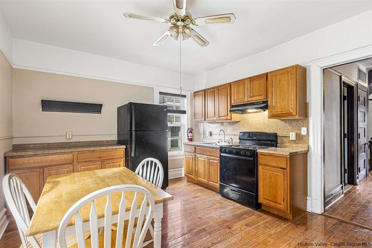 Undisclosed Address Kingston, NY 12401 - Photo 30 of 34 a kitchen with stainless steel appliances granite countertop a refrigerator a stove a sink dishwasher and wooden cabinets