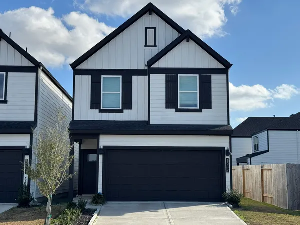 a front view of a house with garage