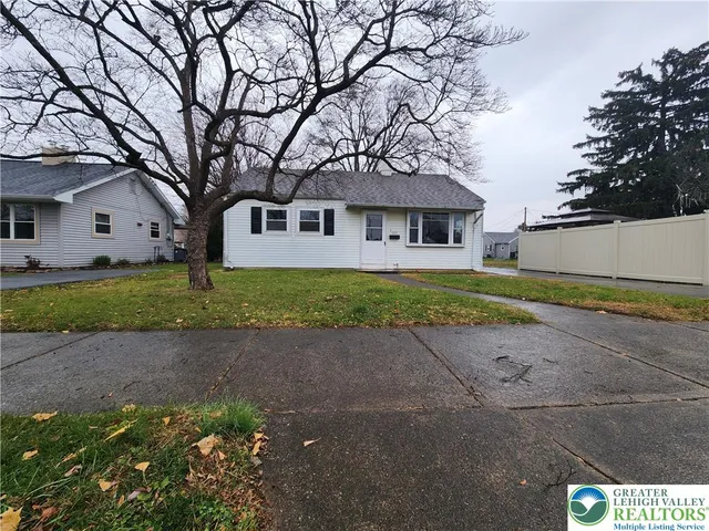 a house that has a tree in front of it