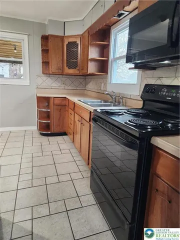 a kitchen with cabinets and appliances