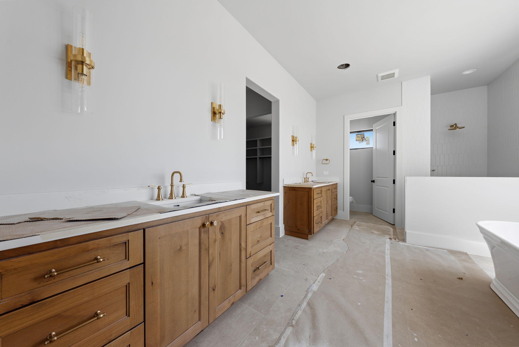 3300 Rm -165 Dripping Springs Dripping Springs, TX 78620 - Photo 11 of 32 a spacious bathroom with a granite countertop sink a mirror and a