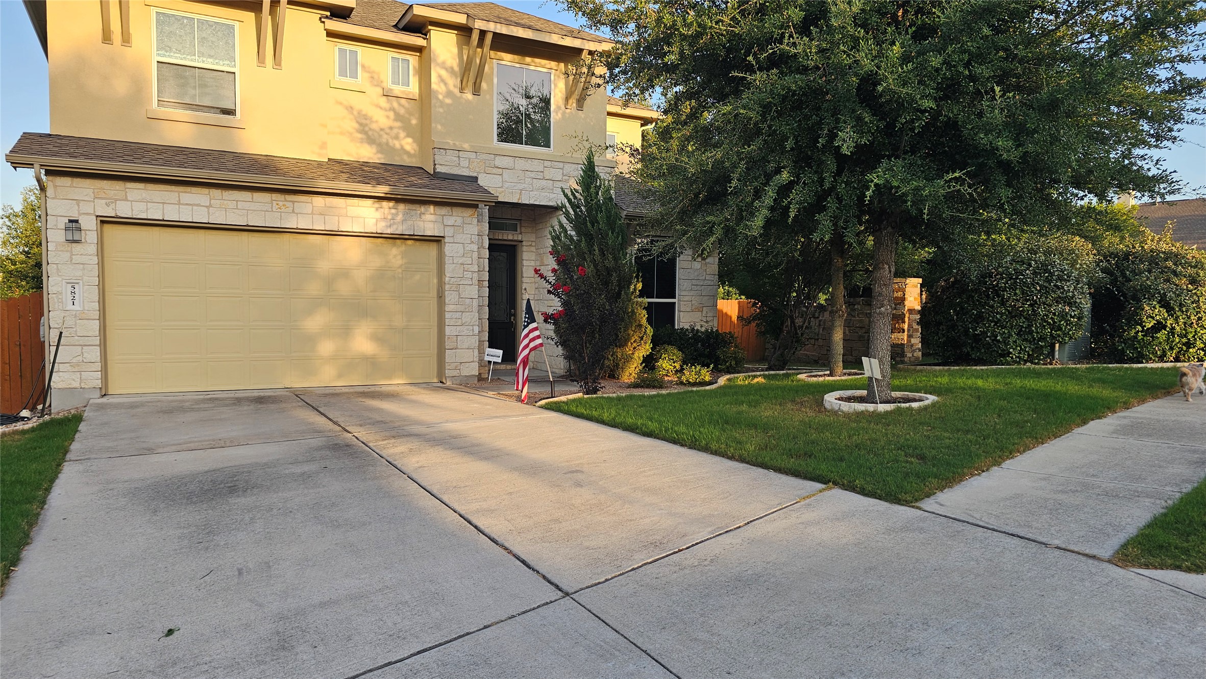 5821 Buchanan Draw Road Austin, TX 78738 - Photo 1 of 18 A well-maintained lawn and sturdy concrete driveway lead to a charming stone and stucco residence with an integrated garage.