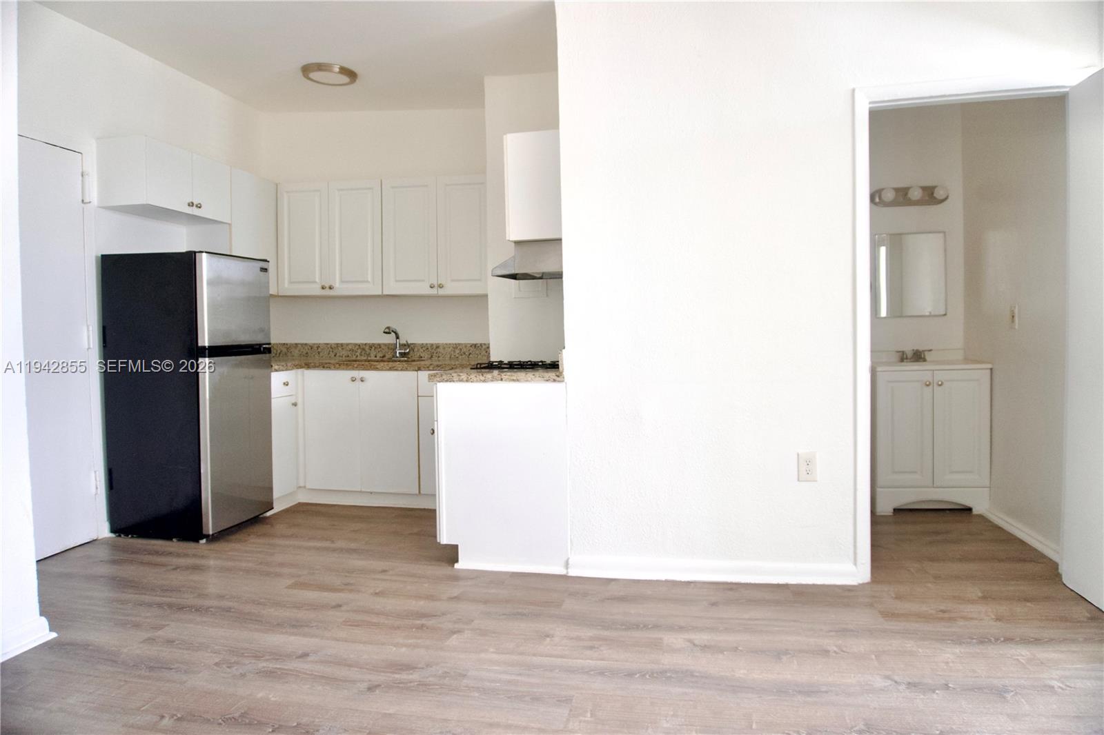 501 Southwest 6th Court, Unit 325 Miami, FL 33130 - Photo 12 of 25 a kitchen with a refrigerator and a stove