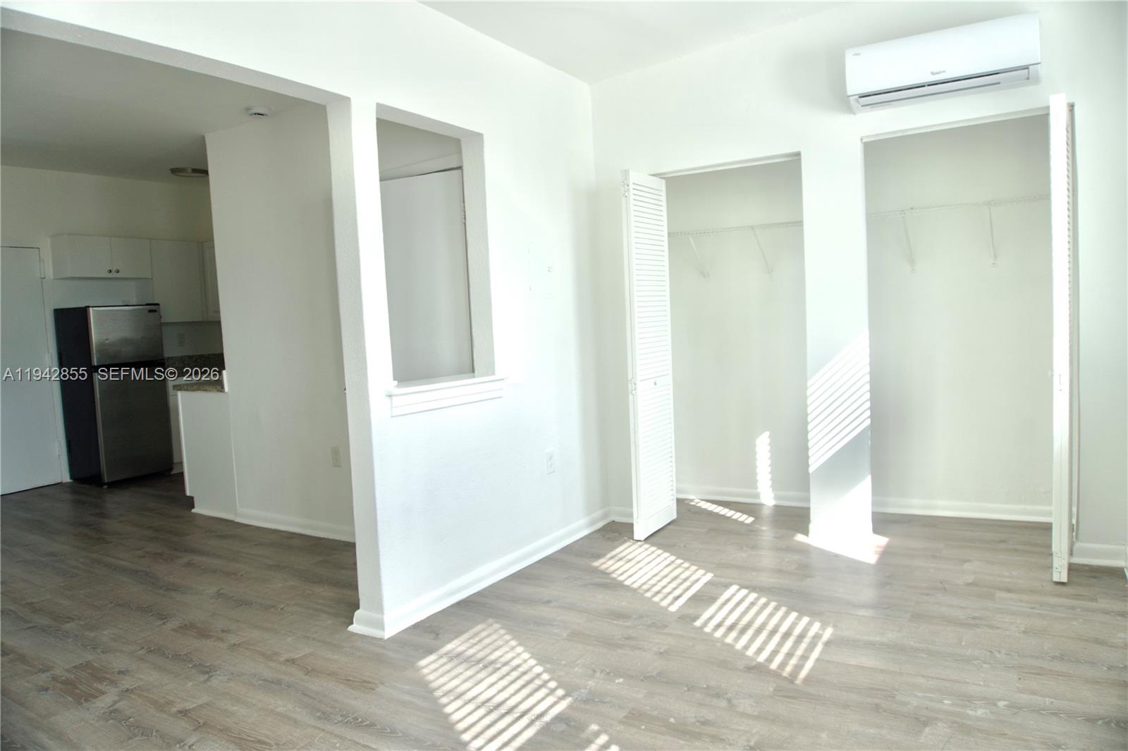 501 Southwest 6th Court, Unit 325 Miami, FL 33130 - Photo 3 of 25 a view of a bedroom with wooden floor & staircase