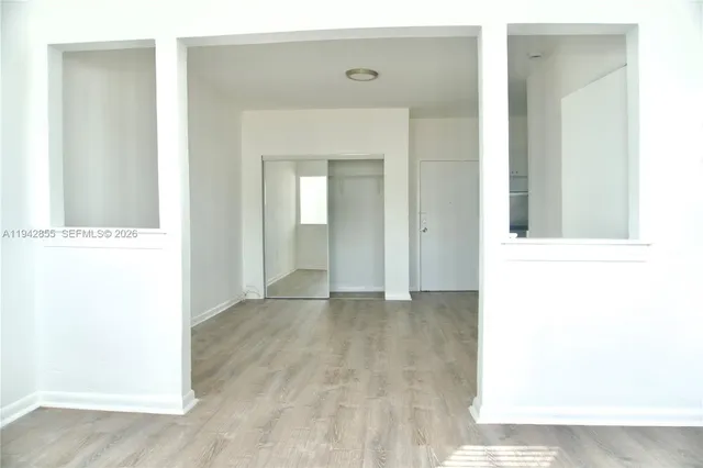 a view of a hallway with wooden floor