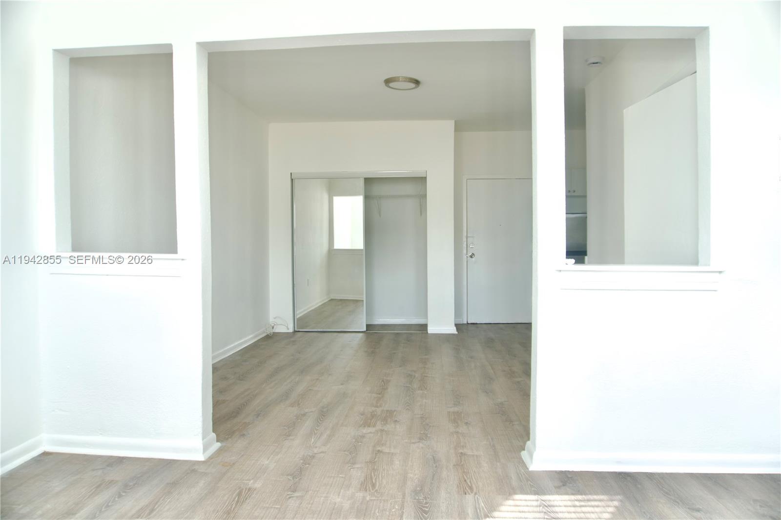 501 Southwest 6th Court, Unit 325 Miami, FL 33130 - Photo 5 of 25 a view of a hallway with wooden floor