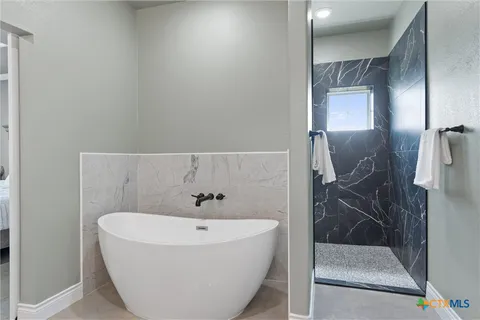 a bathroom with a bathtub and a shower