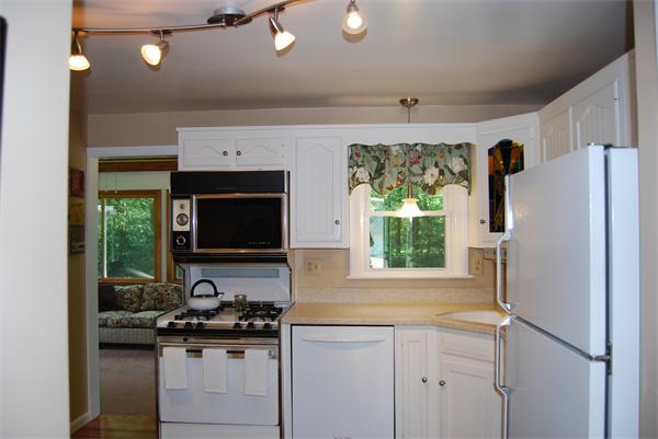 76 Joyce Road Framingham, MA 01701 - Photo 17 of 22 a kitchen with windows a sink and a refrigerator