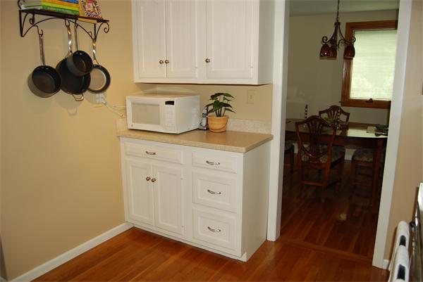 76 Joyce Road Framingham, MA 01701 - Photo 18 of 22 a kitchen with a refrigerator and cabinets