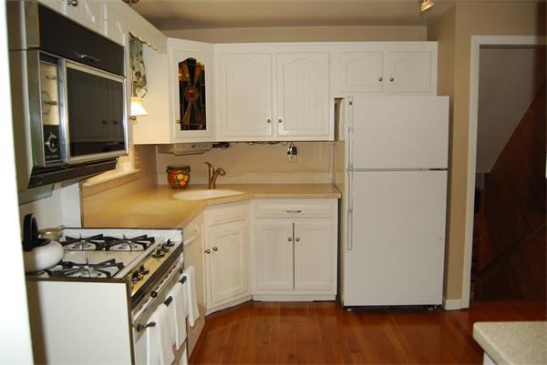 76 Joyce Road Framingham, MA 01701 - Photo 4 of 22 a kitchen with a refrigerator sink stove and cabinets