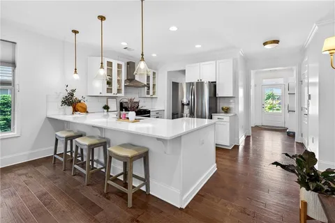 a stove top oven sitting inside of a kitchen