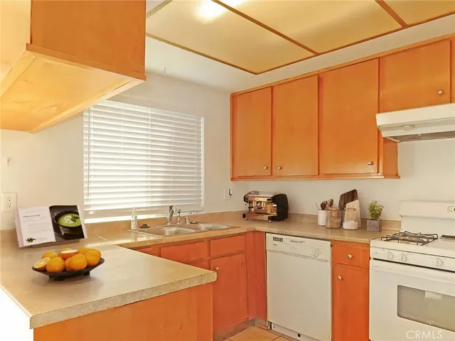 a kitchen with stainless steel appliances a sink a stove and a refrigerator