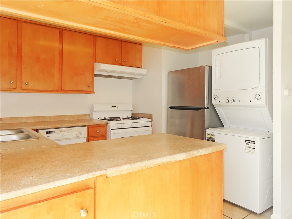 1373 Wheaton Way Riverside, CA 92507 - Photo 17 of 34 a kitchen with a refrigerator and a sink