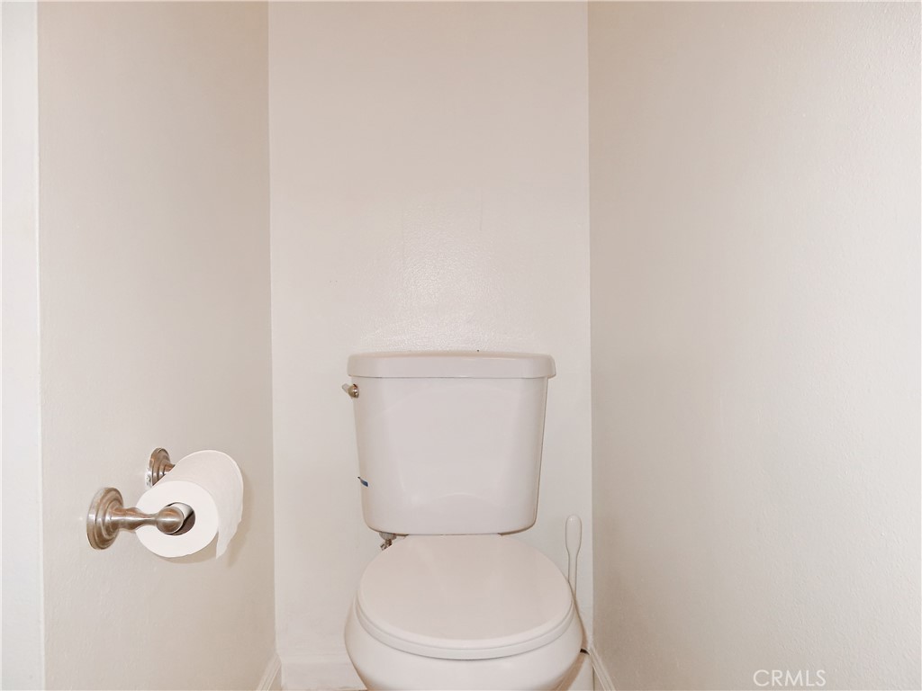 1373 Wheaton Way Riverside, CA 92507 - Photo 19 of 34 a white toilet sitting next to a bathroom sink