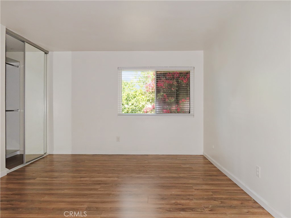 1373 Wheaton Way Riverside, CA 92507 - Photo 22 of 34 a view of an empty room with wooden floor and a window