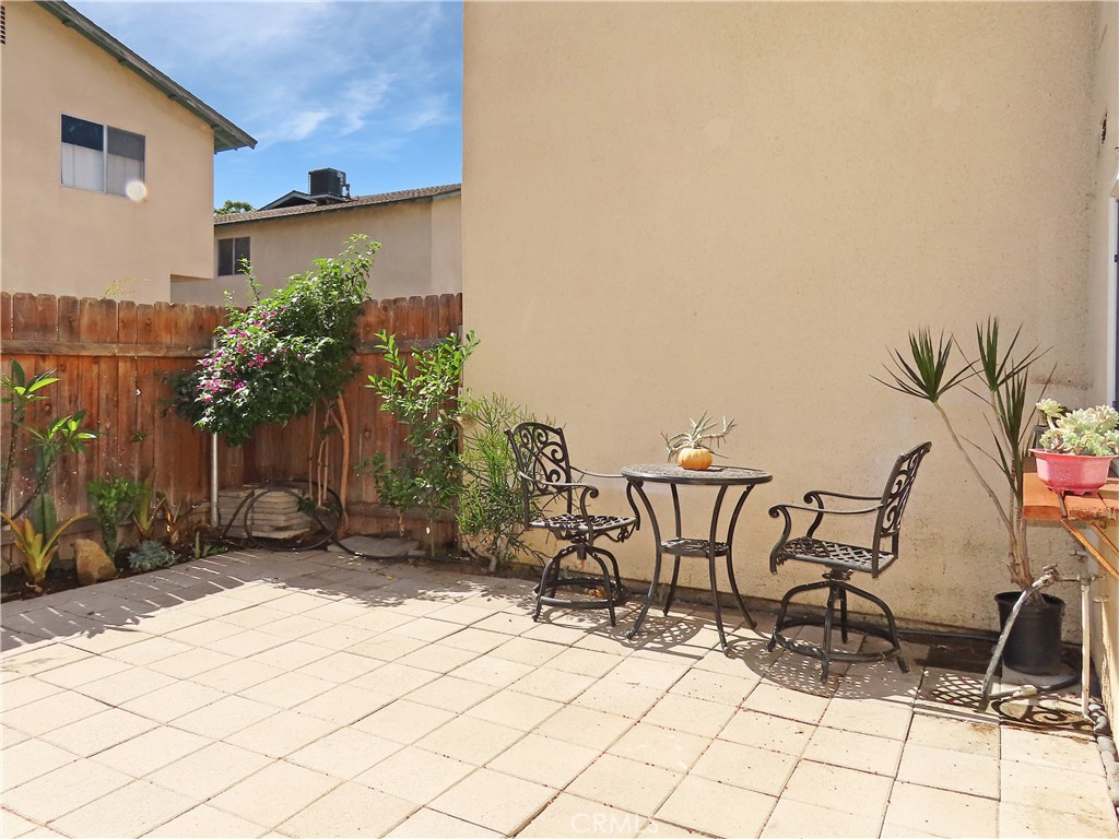 1373 Wheaton Way Riverside, CA 92507 - Photo 25 of 34 a view of a patio with table and chairs with wooden floor and plants