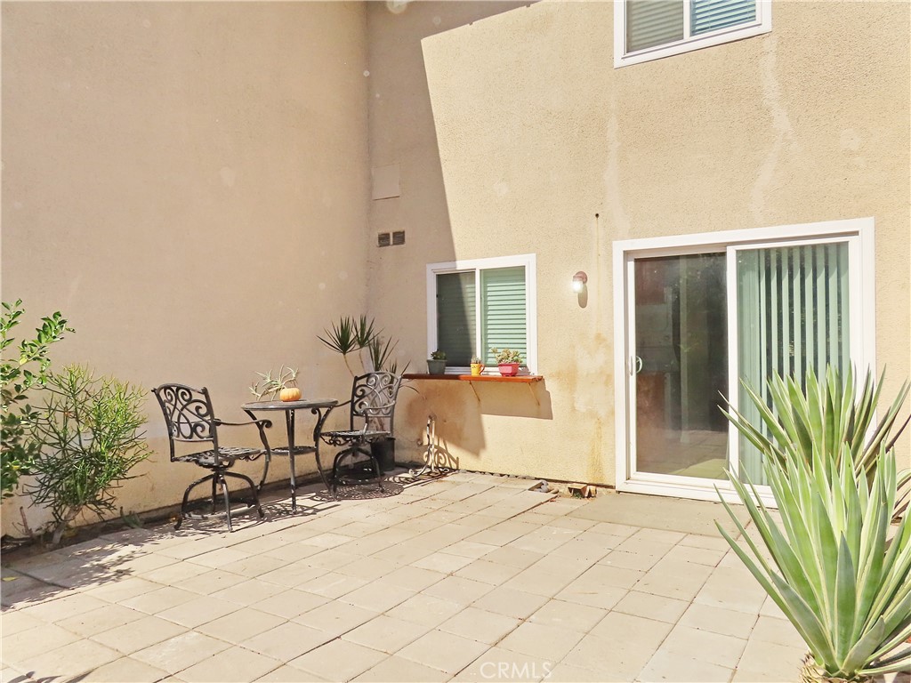 1373 Wheaton Way Riverside, CA 92507 - Photo 28 of 34 a view of a patio with table and chairs and potted plants with wooden fence