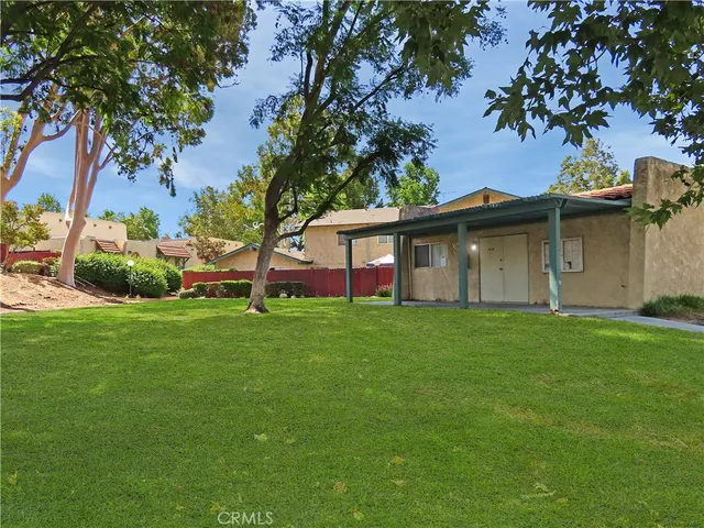 a view of a playground with a tree in the patio