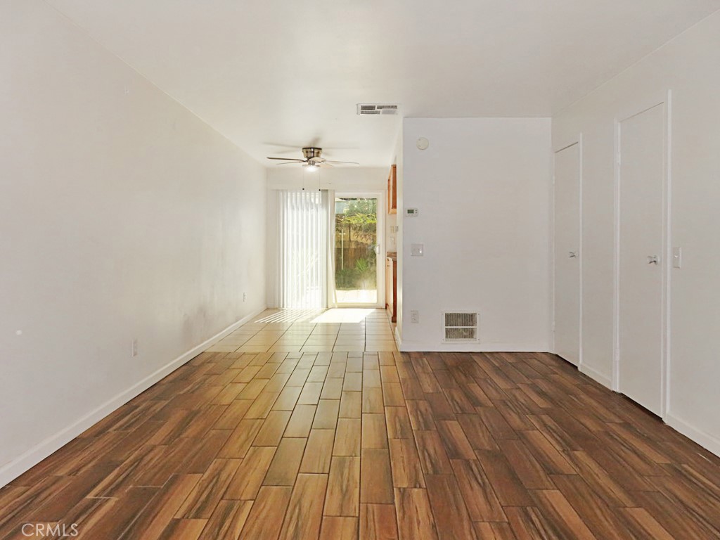 1373 Wheaton Way Riverside, CA 92507 - Photo 6 of 34 a view of an empty room with wooden floor