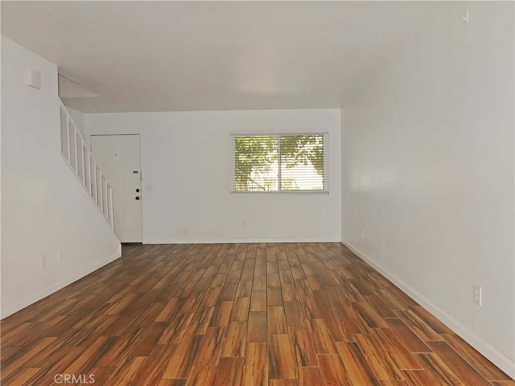 1373 Wheaton Way Riverside, CA 92507 - Photo 10 of 34 an empty room with wooden floor and windows