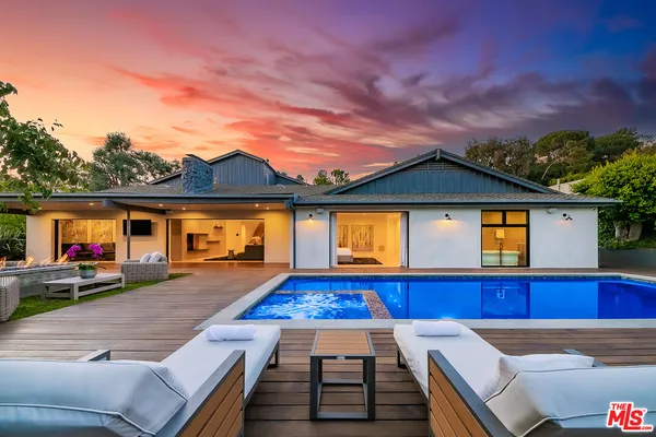 a view of a house with wooden floor and a fireplace