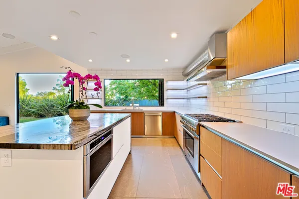 a kitchen with granite countertop a sink and stove