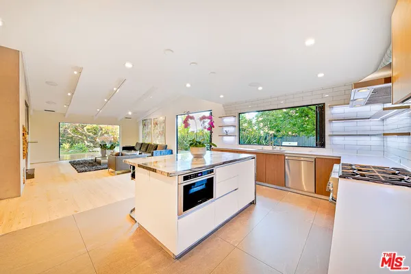 a kitchen with stainless steel appliances a stove a sink a microwave a counter top space and cabinets