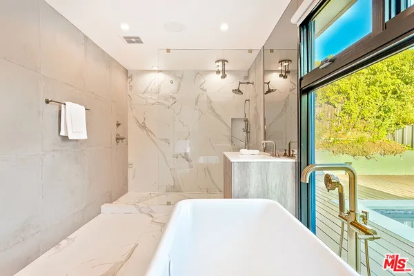 a en suite bathroom with a double vanity sink and a mirror
