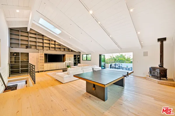 a living room with furniture a flat screen tv and a table