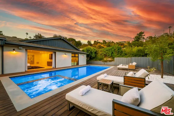 a view of a patio with chairs and a table