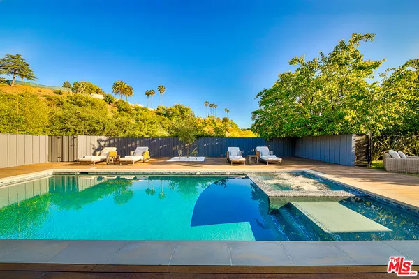 a view of swimming pool with lounge chair