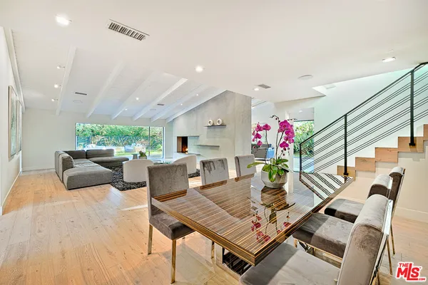 a living room with furniture and flowers