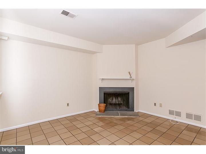 205 Chase Road Wayne, PA 19087 - Photo 4 of 23 a picture of a room with a fireplace and a rug