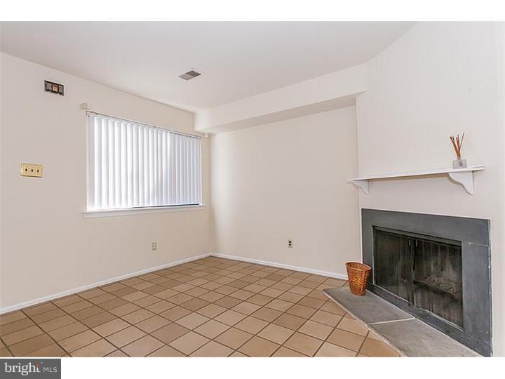 205 Chase Road Wayne, PA 19087 - Photo 5 of 23 a picture of an empty room with a fireplace and a window