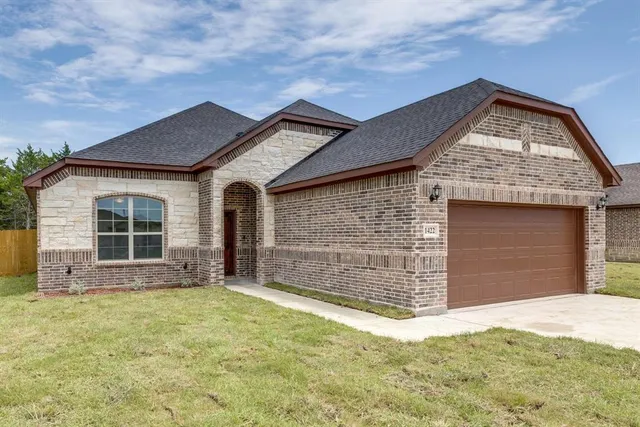 a front view of a house with a yard